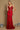 A stunning red fitted corset long formal prom dress, elegantly designed to accentuate the waist and create a flattering silhouette, featuring intricate detailing and a flowing skirt that cascades to the floor.