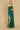 A stunning emerald green prom dress featuring elegant side cutouts, showcasing a blend of sophistication and allure, perfect for a formal evening event.