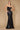 A stunning black long corset mermaid formal prom dress, featuring intricate lace detailing and a fitted bodice that flares out into a dramatic skirt, perfect for an elegant evening event.